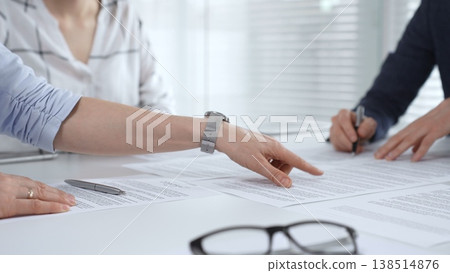 Business executives shaking hands, sealing an agreement after successful negotiations in a bright office, symbolizing partnership, collaboration, and a mutually beneficial deal signing 138514876