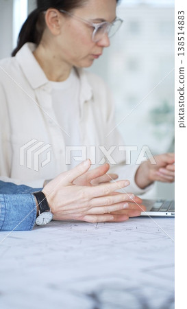 Architects collaborating on architectural project, discussing building design plans, creating new house models, developing urban construction schemes, working in modern office 138514883