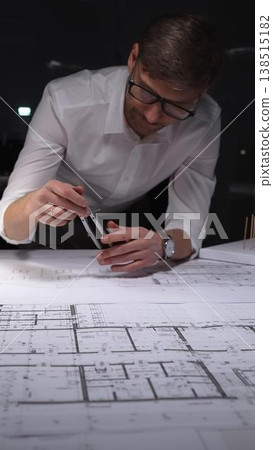 Architect creating technical drawing with compass, designing blueprint on paper for engineering project in office. Concept of architecture and business in low key lighting Architect creating technical drawing with compass, designing blueprint on paper for engineering project in office. Concept of architecture and business in low key lighting 138515182