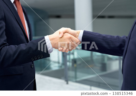 A close-up of businessmen shaking hands, symbolizing a deal or partnership being finalized in the office. A close-up of businessmen shaking hands, symbolizing a deal or partnership being finalized in the office. 138515346