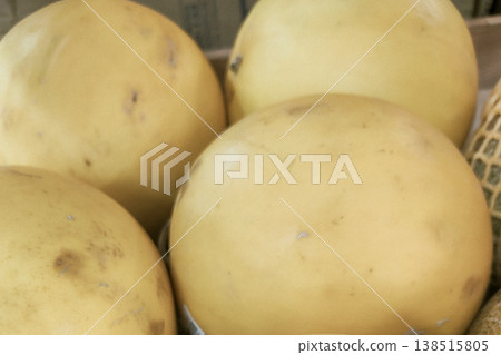 Fresh Organic Melon Displayed at Local Market Stall in Natural Light Fresh Organic Melon Displayed at Local Market Stall in Natural Light 138515805