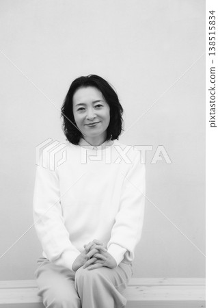 A monochrome portrait of my cheerful mother from my childhood home. A monochrome portrait of my cheerful mother from my childhood home. 138515834