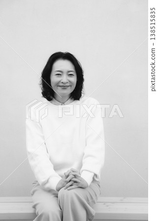 A monochrome portrait of my cheerful mother from my childhood home. A monochrome portrait of my cheerful mother from my childhood home. 138515835