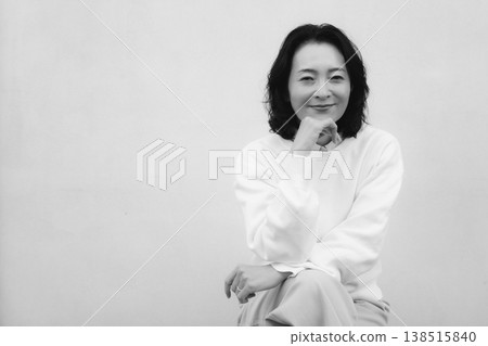 A monochrome portrait of my cheerful mother from my childhood home. A monochrome portrait of my cheerful mother from my childhood home. 138515840