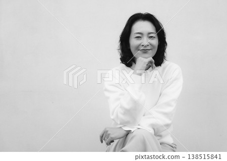A monochrome portrait of my cheerful mother from my childhood home. A monochrome portrait of my cheerful mother from my childhood home. 138515841