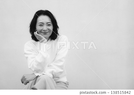 A monochrome portrait of my cheerful mother from my childhood home. A monochrome portrait of my cheerful mother from my childhood home. 138515842
