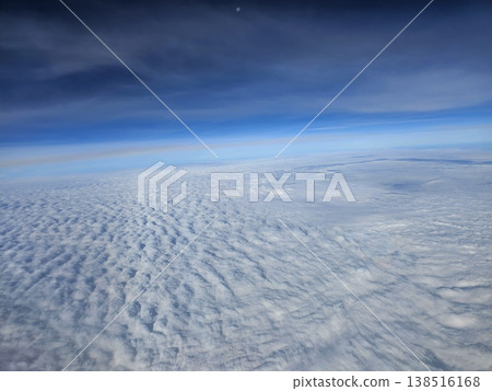 Beautiful landscape aerial shot of endless white stratocumulus clouds blanketed beneath the earth's blue atmosphere during a flight to Andaman. 138516168