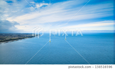 A view from the mouth of a small stream in eastern Toyama Prefecture in early spring, showing the Northern Alps and offshore wind turbines hidden by clouds. A view from the mouth of a small stream in eastern Toyama Prefecture in early spring, showing the Northern Alps and offshore wind turbines hidden by clouds. 138516596