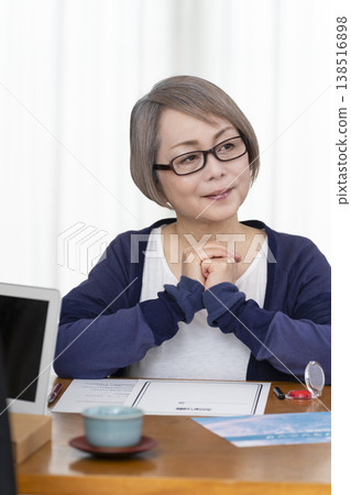 A senior woman signs and seals a life insurance contract. A senior woman signs and seals a life insurance contract. 138516898