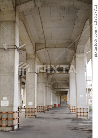 A view of a parking lot under a railway overpass. A view of a parking lot under a railway overpass. 138517712