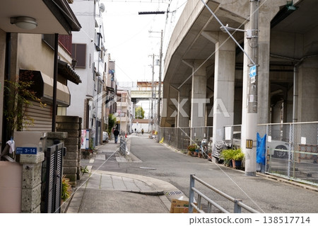 A cityscape with a railway overpass running nearby. 138517714