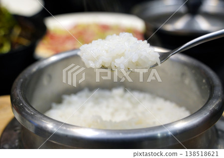 Freshly Cooked Korean Stone Pot Rice, Steam Rising from Hot Stainless Steel Pot, Traditional Asian Meal 138518621