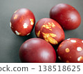 Hand-dyed Easter eggs with traditional natural patterns. Deep red and maroon tones highlight leaf motifs for a rustic holiday look 138518625