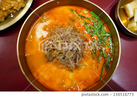 Traditional Korean Spicy Beef Soup Yukgaejang in Brass Bowl, Shredded Beef with Scallions in Red Chili Broth, Authentic K-Food Hangover Soup 138518773