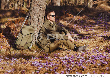 Man Hiker Sitting in Forest with Crocus Flowers 138519690