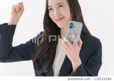 A woman with a suit with a smartphone 138520289