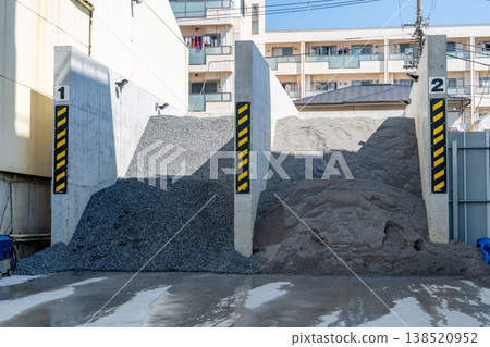 A concrete company's storage area for gravel and sand materials. 138520952