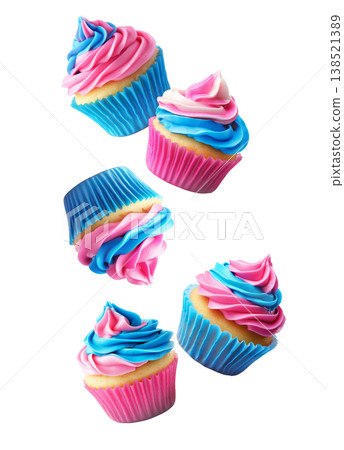 Bright cupcakes with pink and blue swirled frosting and paper wrappers, on white background, concept of festive dessert pattern 138521389