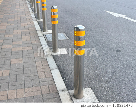 Bollards (passenger barriers) that separate sidewalks from roadways. 138521473
