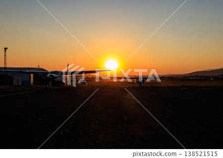 Small propeller airplanes at sunset in Arusha airport, Tanzania Small propeller airplanes at sunset in Arusha airport, Tanzania 138521515