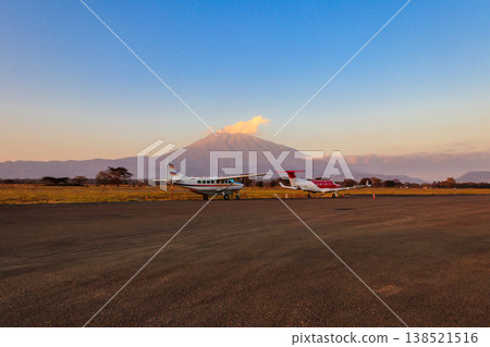 Small propeller airplanes on a background of Meru mountain in Arusha airport, Tanzania Small propeller airplanes on a background of Meru mountain in Arusha airport, Tanzania 138521516