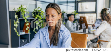 Female employee assembling materials for strategic work meeting Female employee assembling materials for strategic work meeting 138521660