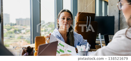 Senior leader discusses strategic development and data insights with team 138521679