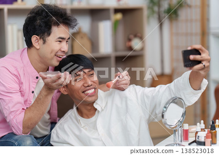 Couple applying makeup and taking a selfie together Couple applying makeup and taking a selfie together 138523018