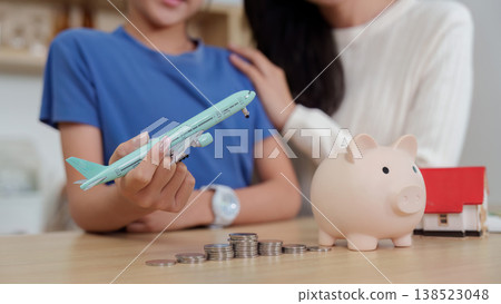 Family teaching financial planning with savings and travel goals Family teaching financial planning with savings and travel goals 138523048