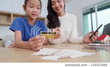 Mother teaching child financial literacy at home Mother teaching child financial literacy at home 138523060