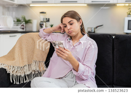 Young woman tired of news feed puts smartphone down closes eyes breathes seeking break from gadgets 138523623