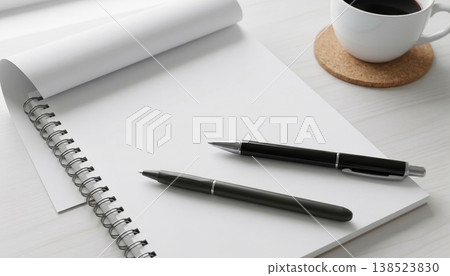 Blank notebook and pens beside a cup of coffee on a table during the daytime Blank notebook and pens beside a cup of coffee on a table during the daytime 138523830