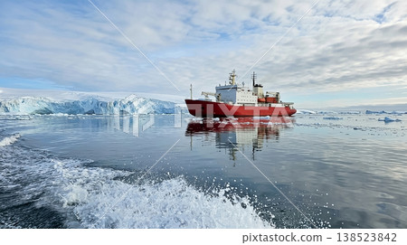 Large red ship sails through icy waters near a glacier under a cloudy sky in the Arctic region Large red ship sails through icy waters near a glacier under a cloudy sky in the Arctic region 138523842