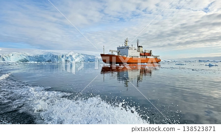 Ship navigates icy waters near glacier under cloudy sky in the Arctic region Ship navigates icy waters near glacier under cloudy sky in the Arctic region 138523871