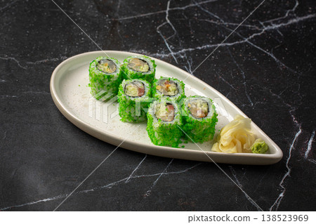 Sushi rolls with green coating and ginger 138523969