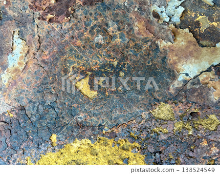 A rusty and dilapidated metal plate 138524549