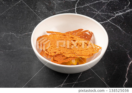 Crispy tuile dessert with cream in bowl Crispy tuile dessert with cream in bowl 138525036