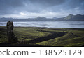Rough volcanic landscape with mountains, glacial rivers and heavy clouds above, Iceland 138525129