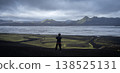 Man standing in front of vast glacial landscape with mountains and glacial river, Iceland 138525131