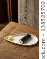 Hand sushi roll with fish and tobiko roe 138525702