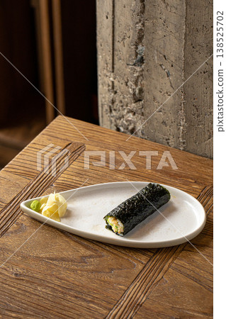 Hand sushi roll with fish and tobiko roe 138525702