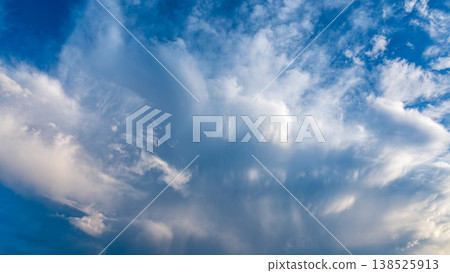 Clouds like sandstorms drifting by at summer twilight. 138525913