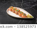 Salmon sushi rolls with spicy topping and herbs 138525973