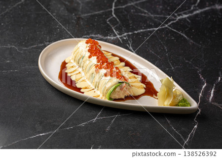Sushi roll with creamy sauce and salmon roe Sushi roll with creamy sauce and salmon roe 138526392