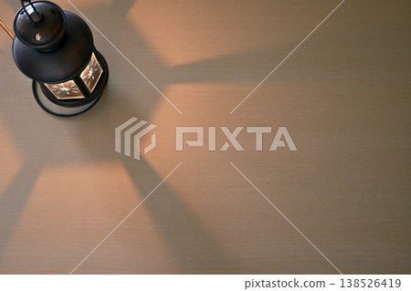 A lantern with a flame on the table A lantern with a flame on the table 138526419