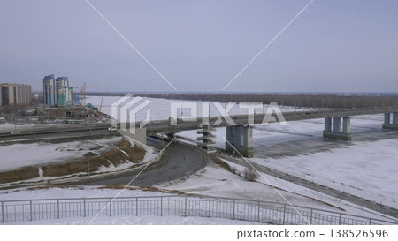 March 22 2026 Barnaul Russia new bridge over Ob River connecting Central District and right bank covered in snow cold early spring cityscape urban infrastructure and winter atmosphere. March 22 2026 Barnaul Russia new bridge over Ob River connecting Central District and right bank covered in snow cold early spring cityscape urban infrastructure and winter atmosphere. 138526596