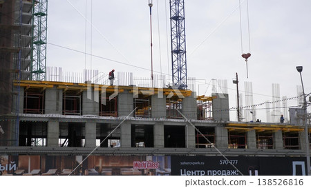 March 22 2026 Barnaul Russia construction of a building at Sakharov Square on the site of former Ferris wheel covered in snow cold early spring cityscape urban environment. 138526816