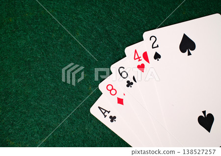 High Card Combination Playing cards arranged on dark green felt casino gambling table closeup detail High Card Combination Playing cards arranged on dark green felt casino gambling table closeup detail 138527257