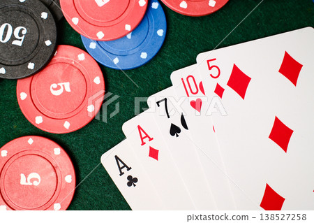 1 Pair Combination playing cards spread beside casino chips on green felt gambling table 1 Pair Combination playing cards spread beside casino chips on green felt gambling table 138527258