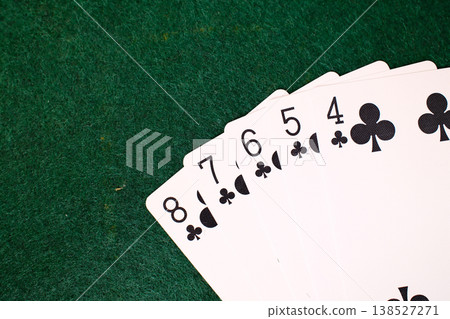 Straight Flush Combination Playing cards arranged on dark green felt casino gambling table closeup detail Straight Flush Combination Playing cards arranged on dark green felt casino gambling table closeup detail 138527271